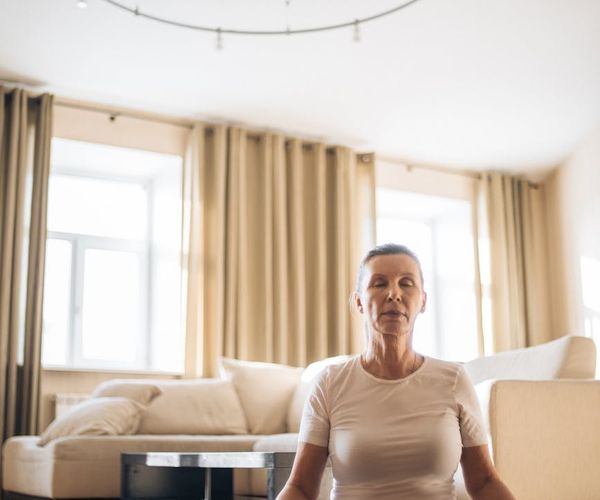 Person in a calm, meditative pose after a light workout.